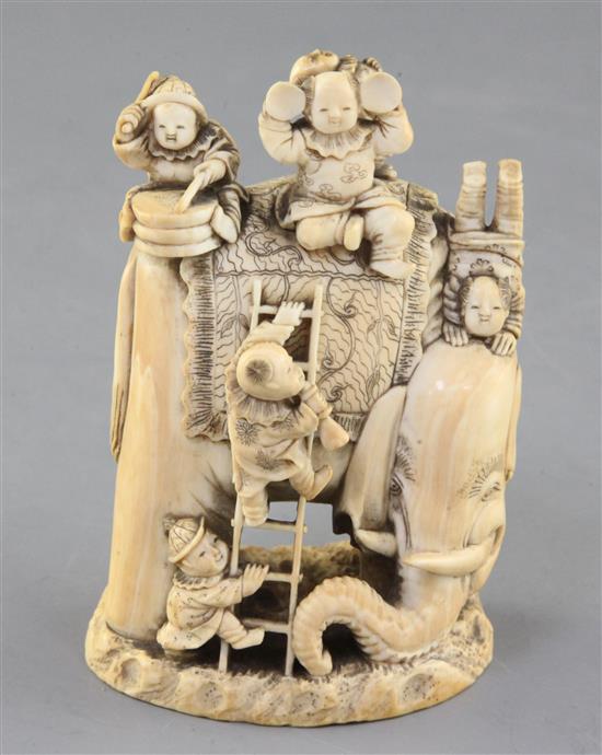 A Japanese ivory okimono of boys clambering on an elephant, Meiji period, height 9.8cm